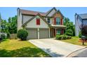 Beautiful two-story home with manicured lawn and driveway at 574 Friars Head Dr, Suwanee, GA 30024