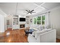 Spacious living room with fireplace, built-in shelves, hardwood floors, coffered ceilings, and large windows at 454 Pine Bluff Dr, Dallas, GA 30157