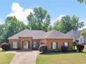 Lovely brick home with manicured lawn and landscaping showcasing curb appeal at 570 Mcgarity Dr, Mcdonough, GA 30252