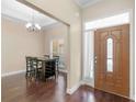 Inviting foyer featuring hardwood floors, elegant lighting, and a view into the dining area at 570 Mcgarity Dr, Mcdonough, GA 30252