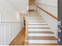 Elegant entry hallway with hardwood floors and an open staircase with wood railing at 214 Trecastle Sq, Canton, GA 30114