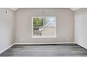 Bright bedroom featuring a large window, modern gray floors, and a spacious closet at 381 New Jersey Ave Nw, Atlanta, GA 30314