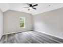 Bright room with a ceiling fan, modern gray floors, and a large window at 381 New Jersey Ave Nw, Atlanta, GA 30314