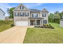 Charming two-story brick home featuring a well-manicured lawn and inviting front porch at 4323 Cannon Walk, Ellenwood, GA 30294