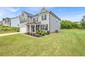 Side view of a two-story home with brick and siding, showcasing the manicured lawn at 4323 Cannon Walk, Ellenwood, GA 30294