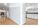 Bright living room with hardwood floors, fireplace, and open layout to the kitchen at 52 Sutton Pl, Avondale Estates, GA 30002