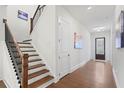 Hallway with hardwood floors and a staircase at 779 Keystone Dr, Woodstock, GA 30188