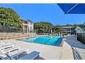 Sparkling community pool with lounge chairs and lush landscaping at 1150 Collier Nw Rd # A1, Atlanta, GA 30318