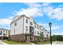 Modern townhome exterior features painted brick and black window frames at 5440 Howington Ct # 190, Buford, GA 30518