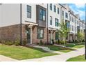 Inviting townhome exterior with brick facade and covered entryway at 5440 Howington Ct # 190, Buford, GA 30518