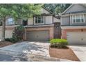 Attractive townhome with a two-car garage, brick facade, and neat landscaping at 109 Creighton Ln, Marietta, GA 30008