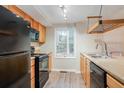 Functional kitchen features black appliances, wooden cabinets, and sleek countertops at 110 Paddock Trl, Peachtree City, GA 30269