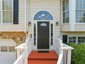 Close-up of the front door with sidelights, transom window, and red stairs at 2355 Woodland Hills Dr, Cumming, GA 30040