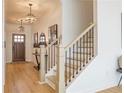 Elegant entryway with hardwood floors, a staircase with iron railings, and decorative light fixtures at 1712 Fulmont Cir, Mableton, GA 30126