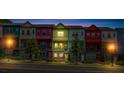 Colorful townhomes bathed in twilight, highlighting their distinctive facades, glowing windows, and inviting ambiance at 2022 Bixby Byway Se Rd, Atlanta, GA 30317