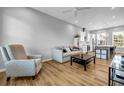 Cozy living room featuring hardwood floors, a plush sofa, and a view into the modern, eat-in kitchen at 2022 Bixby Byway Se Rd, Atlanta, GA 30317