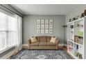 Comfortable living room featuring a sofa, bookshelf and decor at 457 Skiles Ct, Suwanee, GA 30024