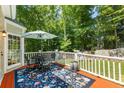 Outdoor deck perfect for entertaining, with a table, chairs, and view of the backyard at 120 Ashewoode Downs Ln, Alpharetta, GA 30005