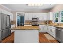 Bright kitchen with stainless steel appliances, granite countertops, and ample cabinet space at 120 Ashewoode Downs Ln, Alpharetta, GA 30005