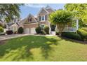 Beautiful front lawn and exterior view of this brick two-story home with white trim at 2030 Darien Park Dr, Roswell, GA 30076