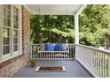 Relaxing porch swing with a comfy neutral and blue pillows, offering a tranquil outdoor retreat at 2030 Darien Park Dr, Roswell, GA 30076