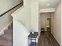 Bright entryway with wood floors, white trim, staircase, and space for a table at 261 Mahone Dr, Lilburn, GA 30047
