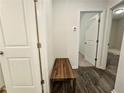 Hallway featuring wood floors, a bench, and doorways leading to other rooms at 261 Mahone Dr, Lilburn, GA 30047