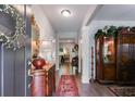 Elegant foyer featuring hardwood floors, antique furniture, and a decorative mirror, showcasing classic charm at 525 Clinton Dr, Temple, GA 30179