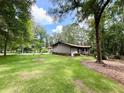Well-manicured lawn and mature trees frame this cozy home at 125 Cannongate Cir, Sharpsburg, GA 30277