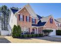 Charming two-story brick home with manicured landscaping and a welcoming entrance at 3258 Kessock Ridge Trl, Snellville, GA 30039