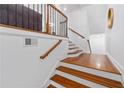 Elegant staircase with hardwood steps, white risers, and a decorative railing, offering a warm welcome at 4089 Thorndale Ln # 13, Smyrna, GA 30080