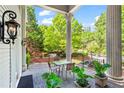 Relaxing porch view with decorative lighting, potted plants, and serene green surroundings at 893 Piedmont Ne Ave # 5, Atlanta, GA 30309