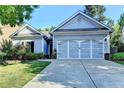 Charming single-story home with a well-manicured lawn and a two-car garage in a suburban neighborhood at 2220 Lily Valley Dr, Lawrenceville, GA 30045