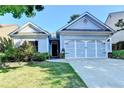 Charming single-story home with a well-manicured lawn and a two-car garage in a suburban neighborhood at 2220 Lily Valley Dr, Lawrenceville, GA 30045