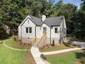 Quaint painted brick home featuring well-maintained landscaping and inviting front steps at 2249 Beecher Sw Rd, Atlanta, GA 30311