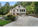 Back of home with painted brick, a garage and long driveway at 2249 Beecher Sw Rd, Atlanta, GA 30311