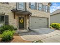 Close-up of a beautifully maintained home showcasing a two-car garage and a decorated front entrance at 4275 Hunters Walk Way, Cumming, GA 30028