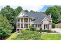 Beautiful two-story brick home boasting a well-maintained lawn and a charming, covered front porch at 1867 Miramonte Way, Lawrenceville, GA 30045