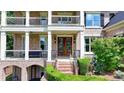 Grand entrance featuring a detailed doorway, brick steps, arched entryway and beautiful landscaping at 1867 Miramonte Way, Lawrenceville, GA 30045