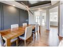 Dining room with grey accent wall, hardwood floors, and statement lighting at 2900 Waterford Dr Sw, Conyers, GA 30094