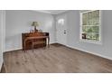Welcoming entryway featuring hardwood floors, piano, and a front door with glass panels at 3924 Devonshire Dr, Marietta, GA 30066