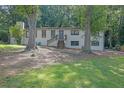Lovely painted brick home with mature trees in the front yard and side entrance at 3924 Devonshire Dr, Marietta, GA 30066