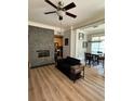 Open living room featuring hardwood floors, fireplace, and view into the dining area and kitchen at 77 Peachtree Ne Pl # 211, Atlanta, GA 30309