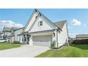 Well-maintained two-story home showcasing a gray two-car garage and a lush green lawn at 35 Henson Farm Dr, Loganville, GA 30052