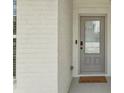 Close-up of a front door and brick wall with a welcome mat at 35 Henson Farm Dr, Loganville, GA 30052