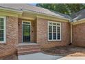 Elegant brick home featuring a decorative glass front door, sidelights, and a charming brick facade at 5195 Overbend Trl, Suwanee, GA 30024