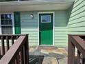 Inviting front entry with a tiled porch and bright green door at 110 Stagecoach Trl, Stockbridge, GA 30281
