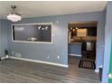 Bright living room with modern chandelier and view to the kitchen at 110 Stagecoach Trl, Stockbridge, GA 30281
