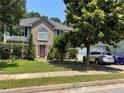 Charming two-story home with a brick facade, mature trees and well-manicured landscaping, offering great curb appeal at 3140 Ridge Hill Pkwy, Douglasville, GA 30135