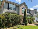 Charming two-story home with brick accents, a large front window, and lush landscaping, offering a welcoming entrance at 3140 Ridge Hill Pkwy, Douglasville, GA 30135